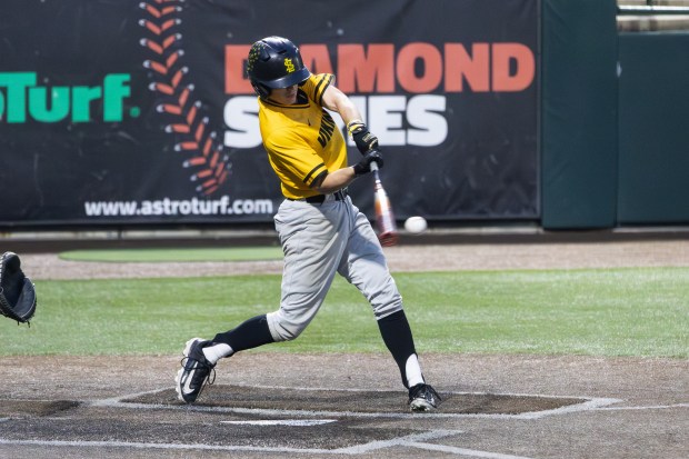 St. Laurence's Daniel Coyle (1) hits the ball against Lemont during the Do It Steve's Way Tournament championship game at Ozinga Field in Crestwood on Saturday, May 24, 2025. (Troy Stolt for the Daily Southtown)