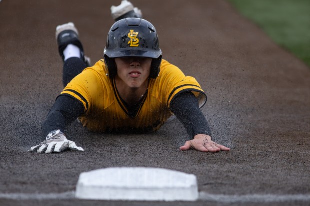 St. Laurence's Connor Marino (23) steals third base against Lemont during the Do It Steve's Way Tournament championship game at Ozinga Field in Crestwood on Saturday, May 24, 2025. (Troy Stolt for the Daily Southtown)