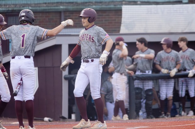 Lockport's Brendan Mecher (10) celebrates with his teammates after hitting a home run against Lincoln-Way East during a Southwest Suburban Conference game in Lockport on Friday, May 16, 2025. (Troy Stolt for the Daily Southtown)