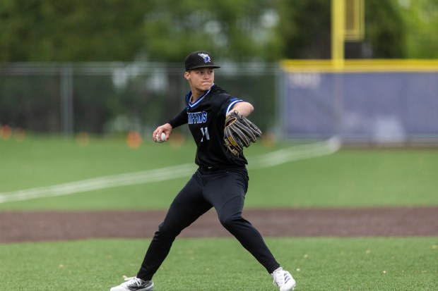 Lincoln-Way East's Owen Lense (11) fields a bunt just off the mound against Sandburg during a Southwest Suburban Conference game in Orland Park on Wednesday, May 21, 2025. (Vincent D. Johnson / for the Daily Southtown)