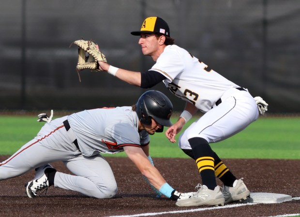 Andrew's Robby Pursel keeps Lincoln-Way West's Conor Essenburg on 1st during the baseball game in Tinley Park on Wednesday, May. 7, 2025. (James C. Svehla / for the Daily Southtown)