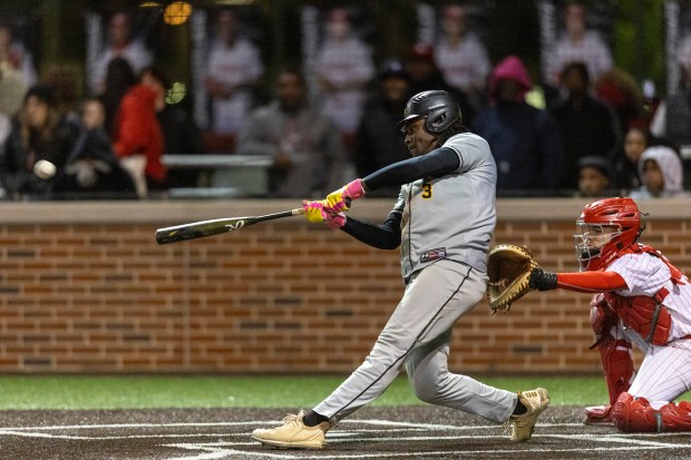 Marian Catholic's Jonathan Trotter (3) hits a two-run double in the top of the sixth inning to put the Spartans ahead of Homewood-Flossmoor to during a nonconference game in Flossmoor on Friday, May 2, 2025. (Vincent D. Johnson / for the Daily Southtown)