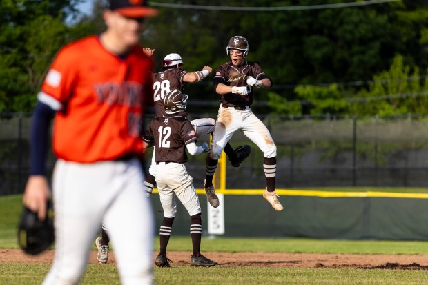 After hitting a walk-off single, Mount Carmel's Brady Holland (33), celebrates with Joey Ireland (28) and Haiden Lajcin (12) during the Class 4A Mount Carmel Regional semifinal against Whitney Young in Chicago on Wednesday, May 28, 2025. (Vincent D. Johnson / for the Daily Southtown)
