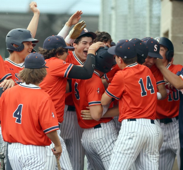 Stagg's Andrew Speh, 5, is celebrated by teammates after scoring a run during the Class 4A Stagg Regional semifinal baseball game against Marist in Palos Hills on Thursday, May 29, 2025. (James C. Svehla / for the Daily Southtown)