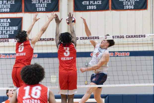 Stagg's Michael Kos (12) spikes the ball against Homewood-Flossmoor during a Southwest Suburban Conference game in Palos Hills on Tuesday, May 6, 2025. (Troy Stolt for the Daily Southtown)