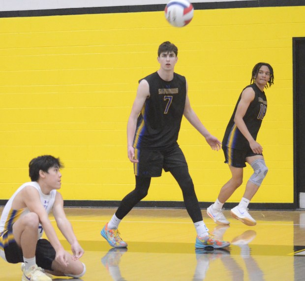 Sandburg's Ethan Cleofe, left, digs a ball against Downers Grove North as JT Snider and Aaron Dennie get ready to run a play during the Richards Invitational in Oak Lawn on Saturday, May 10, 2025. (Jeff Vorva / Daily Southtown)