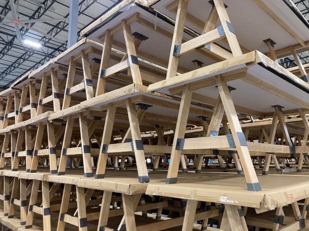 What look like picnic tables are merchandise display tables bound for retailers such as Old Navy, shown at Morgan Li's Chicago Heights warehouse May 20, 2025. (Mike Nolan / Daily Southtown)