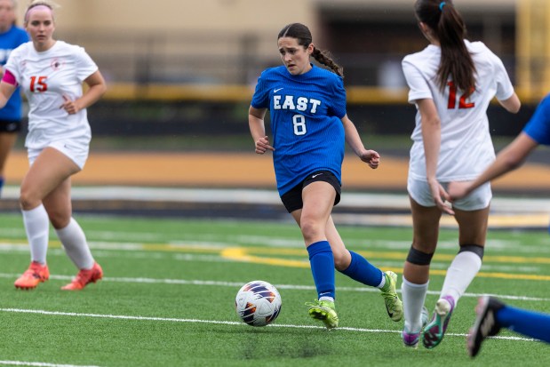 Lincoln-Way East's Adelyn Thomas (8) brings the ball past Lincoln-Way West's Kiersten White (12) in the Class 3A Joliet West Sectional semifinals in Joliet on Tuesday, May 27, 2025. (Vincent D. Johnson / for the Daily Southtown)