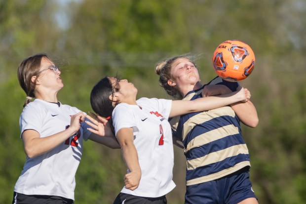 Lemont's Madison Hruby (15) receives a pass with her shoulder against Tinley Park during a South Suburban Conference game in Lemont on Thursday, May 8, 2025. (Troy Stolt for the Daily Southtown)