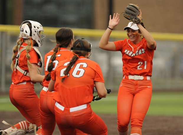 Lincoln-Way West's shortstop Reese Rourke (21) receives congratulations from her teammates after making final out of the inning against Andrew during the Class 4A Andrew Regional final Friday, May 30, 2025 in Tinley Park, IL. (Steve Johnston/for the Daily Southtown)