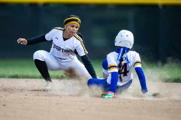 Marian Catholic's Kendyl Rainey (1) tags out De La Salle's Emily Alvarez (4) at second during a nonconference game in Chicago Heights on Thursday, May 22, 2025. (Vincent D. Johnson / for the Daily Southtown)