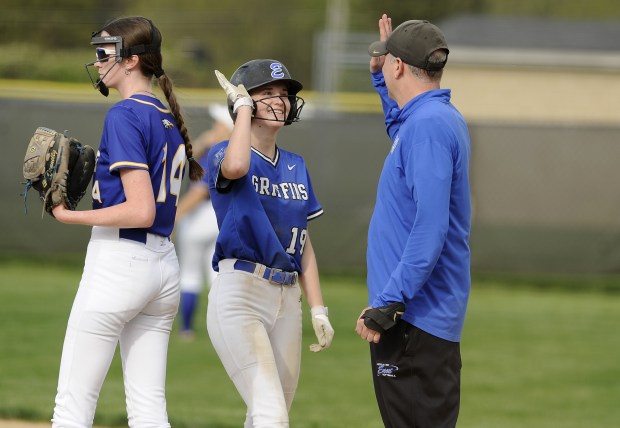 Lincoln-Way East's Zoey Bullock (19) gets a high five from her coach after connect for an RBi giving the Griffins a 3-0 lead over Sandburg during a SouthWest Suburban Conference game Wednesday, May 7, 2025 in Frankfort, IL. (Steve Johnston/for the Daily Southtown)