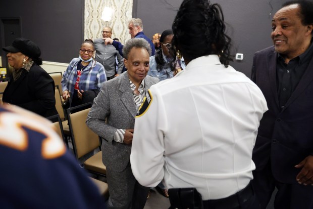 Former Chicago Mayor Lori Lightfoot, center, attends the swearing-in ceremony for Dolton Mayor Jason House in Dolton Monday, May 5, 2025. Lightfoot was hired last year by Dolton trustees to investigate then Mayor Tiffany Henyard's finances. (Terrence Antonio James/Chicago Tribune)