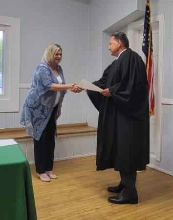 Homer Township Clerk Tami O'Brien shakes hands May 19 with Judge Art Smigielski after taking the oath of office. (Homer Township government)