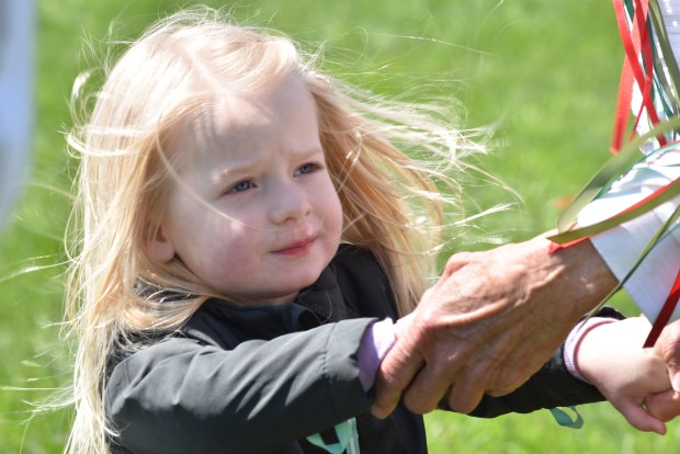 A young girl holds hands with her dance partner May 3, 2025, as part of a Morris Dance at the Stellwagen Farm. The farm, a historic site in Orland Park, hosted a maypole dance and celebration. (Jesse Wright/for the Daily Southtown)