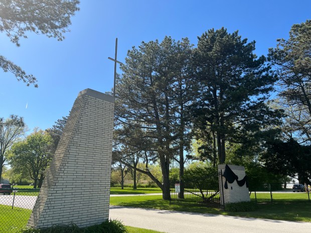 A simple cross marks the entrance to Assumption Catholic Cemetery in Glenwood, where the parents of Pope Leo XIV reside. (Olivia Stevens/Daily Southtown)