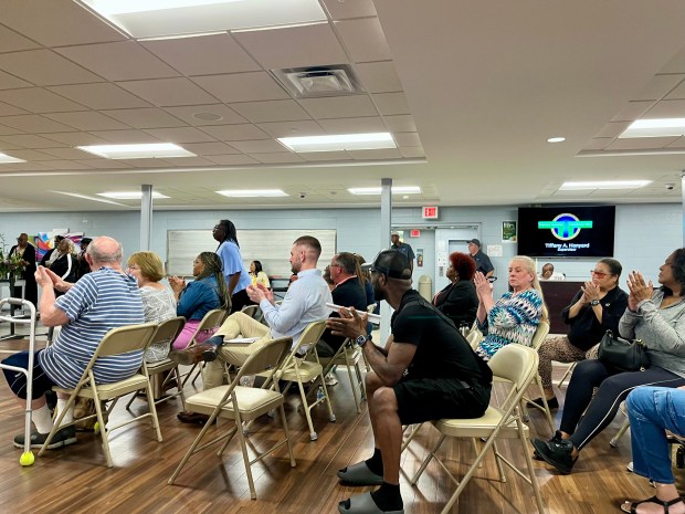 Thornton Township meeting attendees applaud presiding board members during the final regular meeting of embattled Supervisor Tiffany Henyard's tenure. (Olivia Stevens/Daily Southtown)