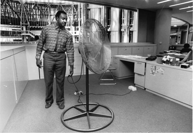 John Campbell, a comptroller's office employee, switches on a fan in the State of Illinois Center in August 1986. Temperatures soared into the 90s in the parts of the building during a heat have. (Ovie Carter/Chicago Tribune)