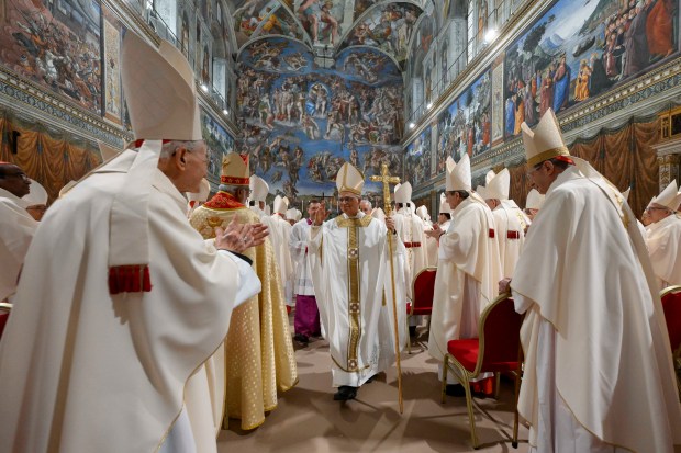 Newly elected Pope Leo XIV, center, leaves after concelebrating Mass with the College of Cardinals inside the Sistine Chapel at the Vatican the day after his election as 267th pontiff of the Roman Catholic Church, May 9, 2025. (Vatican Media)