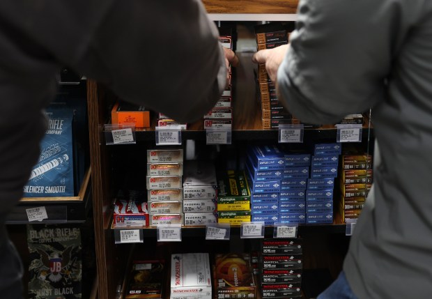 A sales associate, right, assists a customer with ammunition at a firearms store on Jan. 26, 2023, in downstate Effingham. (John J. Kim/Chicago Tribune)