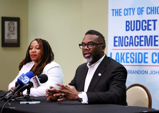 Chicago Budget Director Annette Guzmán, left, and Chicago Mayor Brandon Johnson speak about the city's budget before the start of a community event at the Harold Washington Library Center in Chicago on Feb. 4, 2025. (Terrence Antonio James/Chicago Tribune)