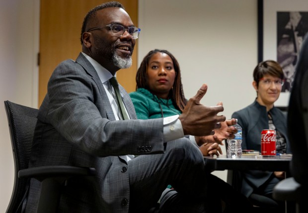 Mayor Brandon Johnson, seated alongside budget director Annette Guzman, center, and CFO Jill Jaworski, meets with the Tribune Editorial Board, Oct. 31, 2024, at City Hall. (Brian Cassella/Chicago Tribune)