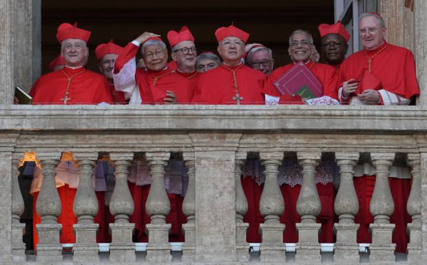 Cardinals, including Chicago Cardinal Blase Cupich at left, appear at the Vatican on May 8, 2025, after the election of Cardinal Robert Prevost as the 267th pope. He chose the name Pope Leo XIV. (Andrew Medichini/AP)