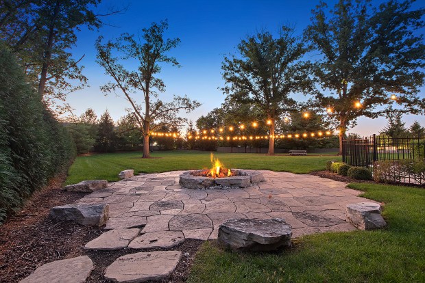 The outdoor features of the house at 320 N. 95th Ave., Frankfort, include an in-ground pool, a covered patio with built-in heaters, a misting system, a full kitchen and a fire-pit lounge. (Jamie Zimpelmann)