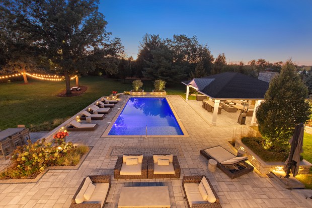 The outdoor features of the house at 320 N. 95th Ave., Frankfort, include an in-ground pool, a covered patio with built-in heaters, a misting system, a full kitchen and a fire-pit lounge. (Jamie Zimpelmann)