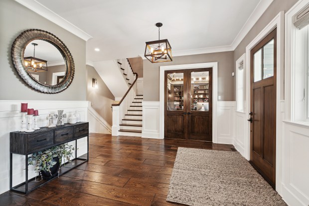 The outdoor features of the house at 320 N. 95th Ave., Frankfort, include an in-ground pool, a covered patio with built-in heaters, a misting system, a full kitchen and a fire-pit lounge. (Jamie Zimpelmann)