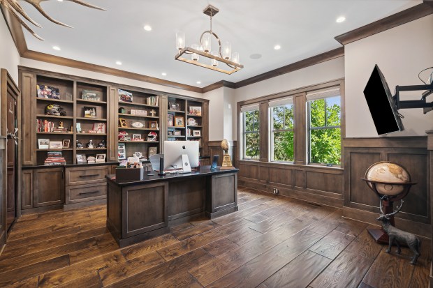 The outdoor features of the house at 320 N. 95th Ave., Frankfort, include an in-ground pool, a covered patio with built-in heaters, a misting system, a full kitchen and a fire-pit lounge. (Jamie Zimpelmann)