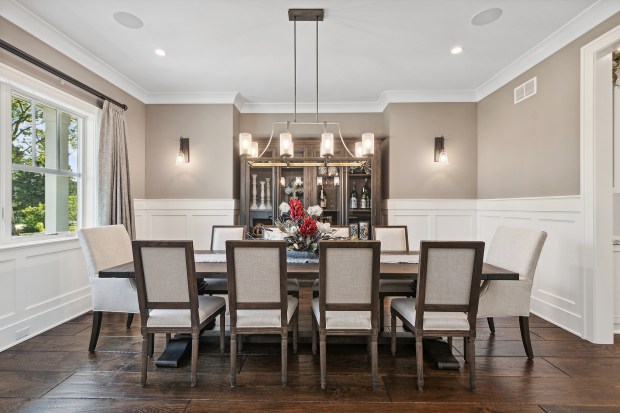 The outdoor features of the house at 320 N. 95th Ave., Frankfort, include an in-ground pool, a covered patio with built-in heaters, a misting system, a full kitchen and a fire-pit lounge. (Jamie Zimpelmann)