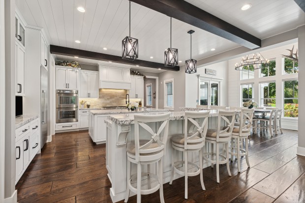 The outdoor features of the house at 320 N. 95th Ave., Frankfort, include an in-ground pool, a covered patio with built-in heaters, a misting system, a full kitchen and a fire-pit lounge. (Jamie Zimpelmann)