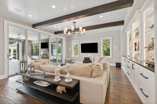 The outdoor features of the house at 320 N. 95th Ave., Frankfort, include an in-ground pool, a covered patio with built-in heaters, a misting system, a full kitchen and a fire-pit lounge. (Jamie Zimpelmann)