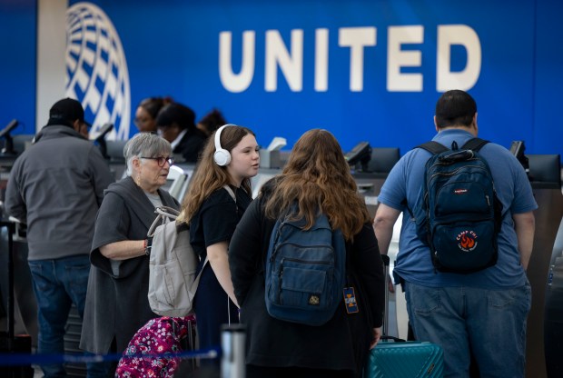 Travelers check in at the United Airlines counter in Terminal 1 at O'Hare International Airport on Nov. 26, 2024. (Brian Cassella/Chicago Tribune)