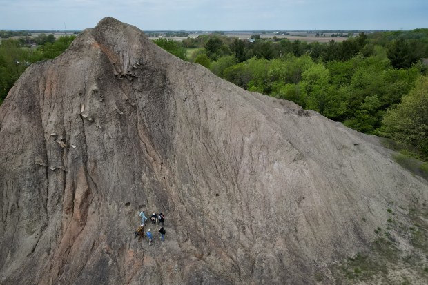 People working in Arjan Mann's laboratory with the Field Museum and the Earth Science Club of Northern Illinois look for fossils at a Mazon Creek fossil bed, which used to be the location of a Peabody Energy mine, May 8, 2025, in Braceville, Illinois. The fossils can be found in the spoil tip, or pile of waste material, from the underground mine. (Audrey Richardson/Chicago Tribune)
