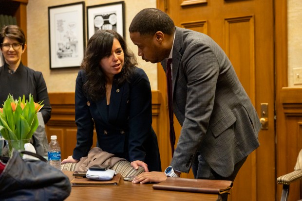 Cristina Pacione-Zayas, chief of staff to Mayor Brandon Johnson, and senior adviser Jason Lee talk between meetings with lawmakers at the Illinois State Capitol on April 30, 2025, in Springfield. (Brian Cassella/Chicago Tribune)