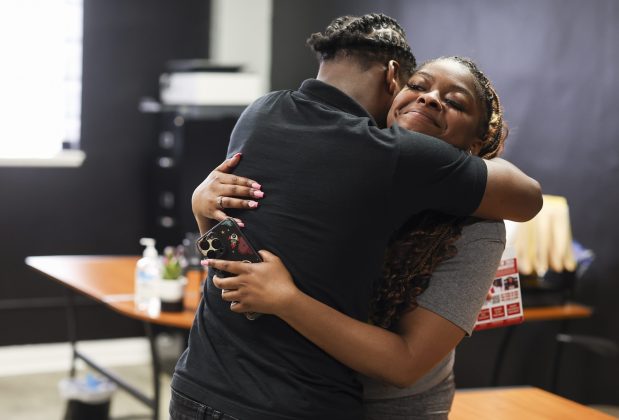Youth member members Jaquan Moore and MaKayah Williams hug after they helped lead a monthly meeting at Think Outside Da Block in Englewood on May 15, 2025. (Eileen T. Meslar/Chicago Tribune)
