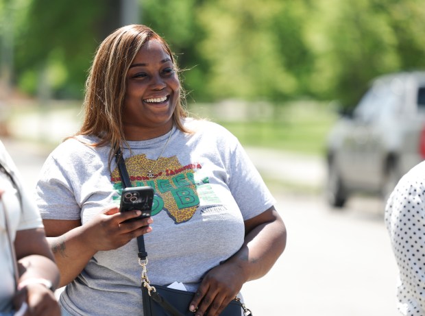 Unoka Obanner, case manager with Think Outside da Block, laughs as she speaks to the Think Outside da Block members in the parking lot of the Ogden Park Fieldhouse on May 13, 2025, as they do a walkthrough for the upcoming event Roll N Peace. (Eileen T. Meslar/Chicago Tribune)