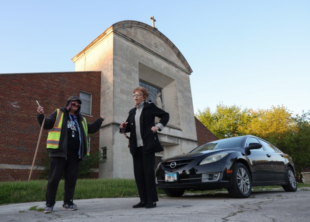 Laura Mathews, left, and Antoinette Nuzzo visit the former St. Mary of the Assumption Church at the corner of South Leyden Avenue and East 137th Street on May 8, 2025, in Chicago. (John J. Kim/Chicago Tribune)