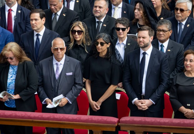 Louis Prevost, the eldest brother of Pope Leo XIV, stands with second lady Usha Vance and Vice President J.D. Vance during the installation Mass in St. Peter's Square on May 18, 2025, at the Vatican. (Brian Cassella/Chicago Tribune)