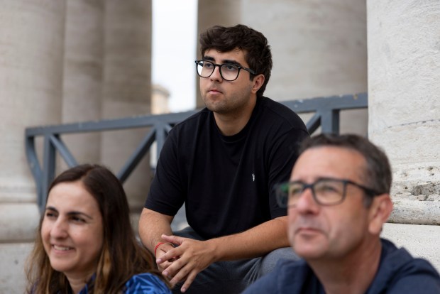 Gui Rodrigues Melo, top, and his father Jorge Melo, right, of Atlanta, visit St. Peter's Square on May 20, 2025, at the Vatican. (Brian Cassella/Chicago Tribune)