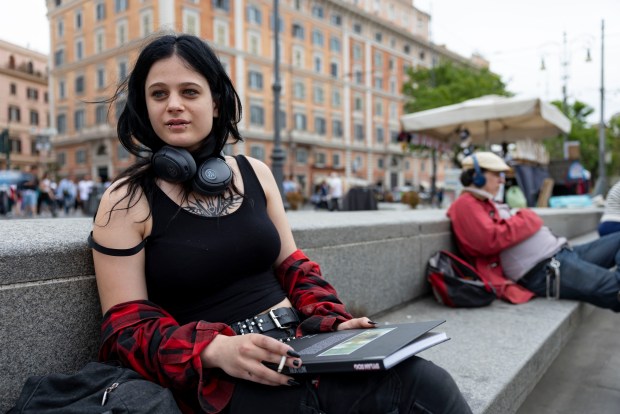 Chiara Valentina Puzzello, of Rome, sits in a piazza near St. Peter's Square on May 20, 2025. (Brian Cassella/Chicago Tribune)