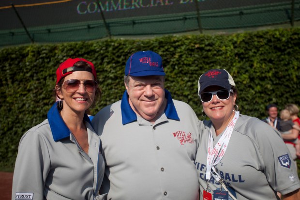 WTMX radio host Kathy Hart, from left, actor George Wendt, and Adalisa Frazzini pose during Woody's Wiffle Ball Classic at Wrigley Field on Aug. 10, 2013, in Chicago. (Armando L. Sanchez/for the Chicago Tribune)