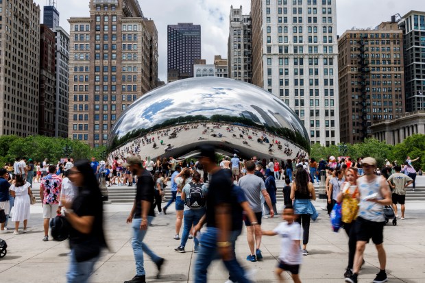Visitors walk around Cloud Gate in Chicago's Millennium Park on June 23, 2024. (Armando L. Sanchez/Chicago Tribune)
