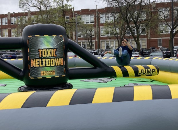 Jefferson Perez hops over the arm of a Toxic Meltdown Machine. (Steve Sadin/For the Lake County News-Sun)