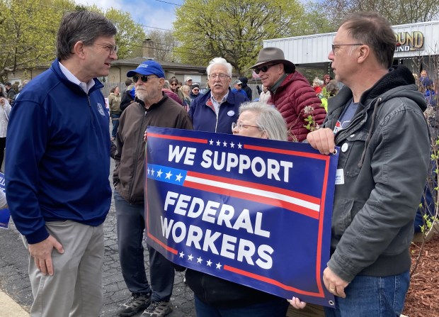 U.S. Rep. Brad Schneider, left, talks to people at a rally for Social Security. (Steve Sadin/for the Lake County News-Sun)