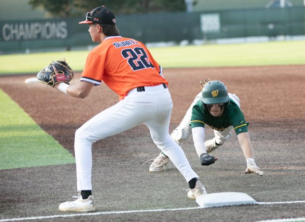 Waubonsie Valley #9 Connor Beren dives back to first ahead of a pickoff attempt to Normal Community first baseman #22 Gavin Swartz during Boys High School Baseball Class 4A Illinois Wesleyan Supersectional Jack Horenberger Field - 300 E Kelsey St, Bloomington, IL . June 09, 2025 (Daryl Wilson/for the Naperville Sun)