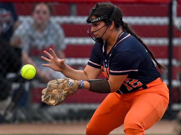 Oswego's Aubriella Garza (12) grabs a bouncing ball along the third base line. Oswego defeated Oak Park River Forest 13-2 at the Louisville Slugger Sports Complex in Peoria, Class 4A state semifinals, Friday, June 13, 2025. (Rob Dicker / for the Beacon News)