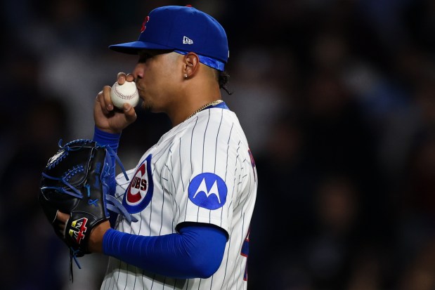 Chicago Cubs pitcher Daniel Palencia (48) kisses a baseball after striking out Colorado Rockies catcher Hunter Goodman (15) to win a game against the Colorado Rockies at Wrigley Field in Chicago on Wednesday, May 28, 2025. (Audrey Richardson/Chicago Tribune)
